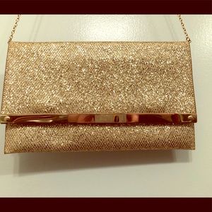 Gold glitter clutch with long chain strap